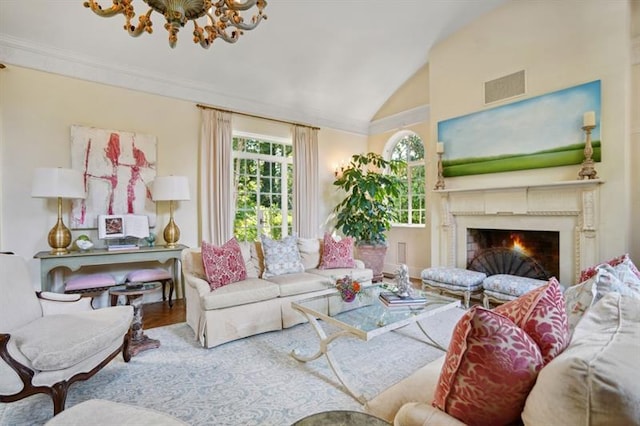 675 W Paces Ferry Rd NW Unit 11, Atlanta, GA 30327 - living room with vaulted ceiling, an inviting chandelier, visible vents, a lit fireplace, and wood finished floors