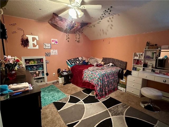 carpeted bedroom featuring a ceiling fan, vaulted ceiling, and a textured ceiling