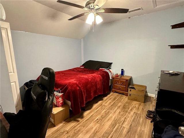 bedroom featuring lofted ceiling, ceiling fan, light wood-type flooring, and visible vents