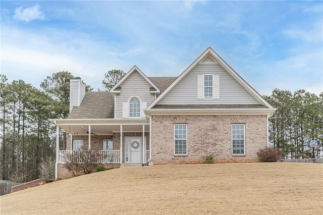 view of front of house with a porch and a front yard