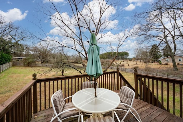 wooden terrace featuring a yard