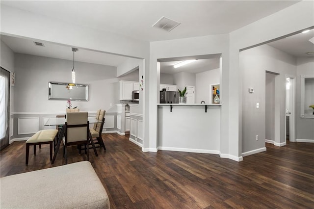 dining area with baseboards, dark wood-style floors, and visible vents