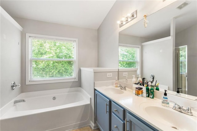 full bathroom with visible vents, a sink, a bath, and double vanity