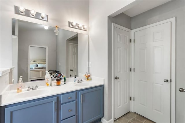 full bath featuring double vanity, a sink, and tile patterned flooring