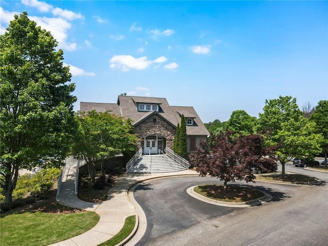 view of front of property featuring french doors and stone siding