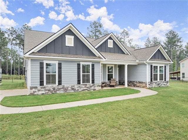 craftsman-style house featuring a patio and a front yard