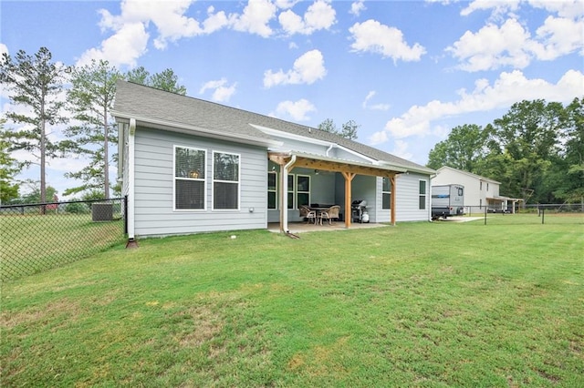 back of house featuring a lawn and a patio area