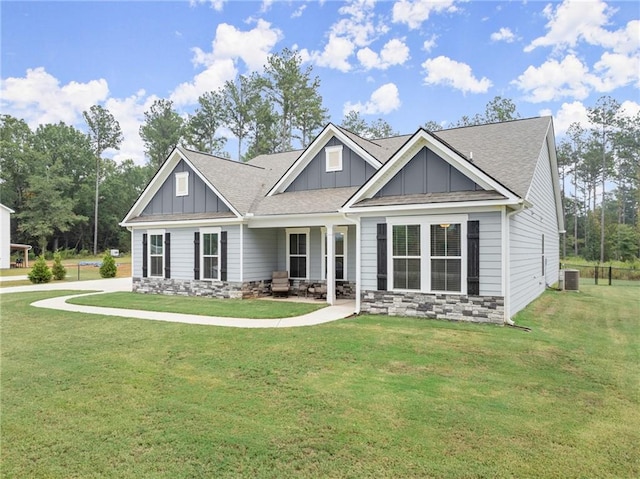 craftsman-style house featuring central air condition unit and a front yard