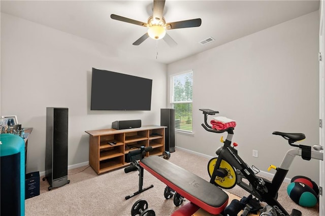 workout room featuring ceiling fan and light colored carpet