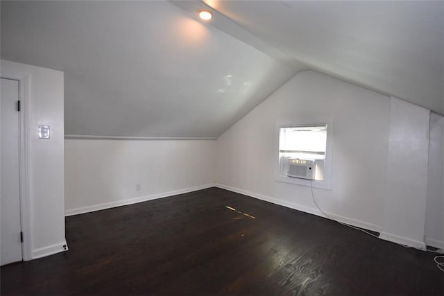 bonus room with vaulted ceiling, wood finished floors, and baseboards