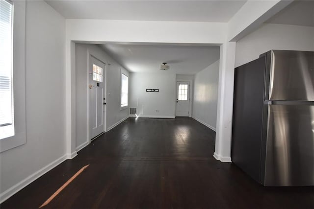 entryway with wood finished floors and baseboards