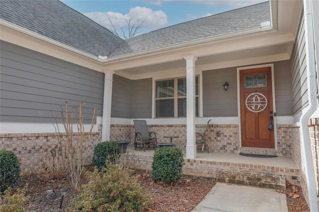 view of exterior entry with a porch