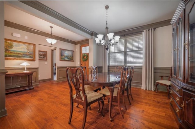 dining space with crown molding, dark hardwood / wood-style floors, and a chandelier