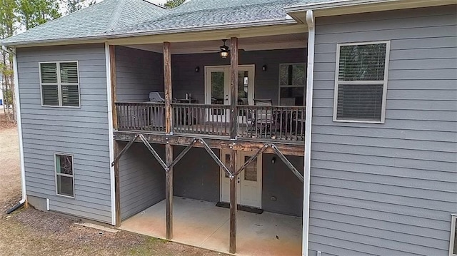 back of property featuring ceiling fan and a patio area