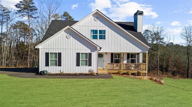 back of house with a lawn and a porch