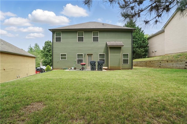 rear view of property with a yard