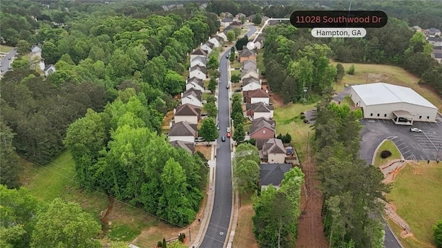 bird's eye view featuring a residential view and a forest view