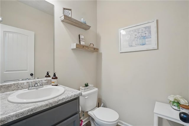 bathroom featuring vanity and toilet