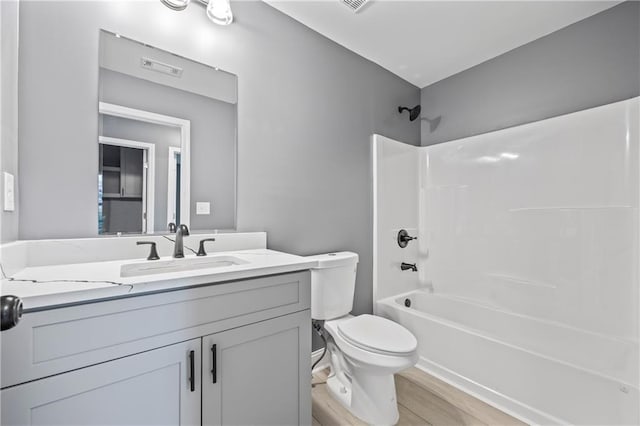 full bathroom with toilet, vanity, and tub / shower combination