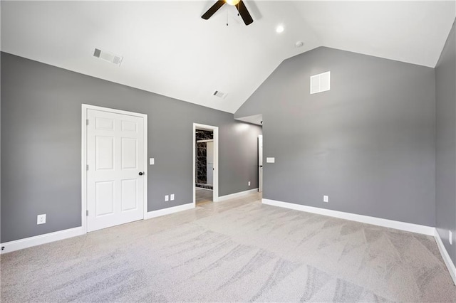 carpeted spare room featuring ceiling fan and high vaulted ceiling