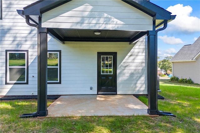 exterior space with a patio area and a lawn