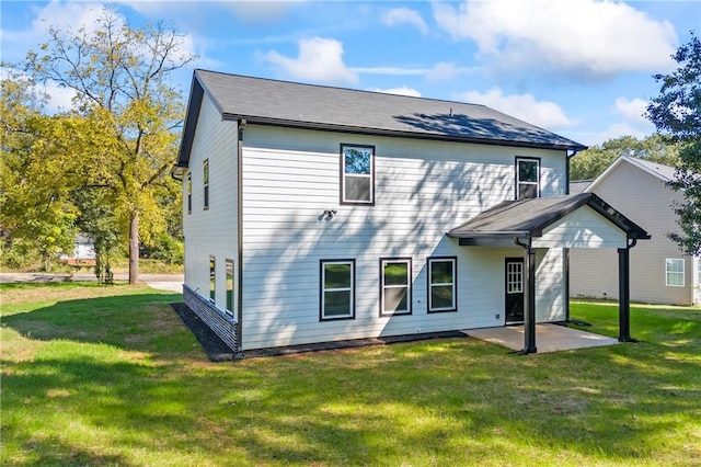 rear view of house featuring a yard and a patio