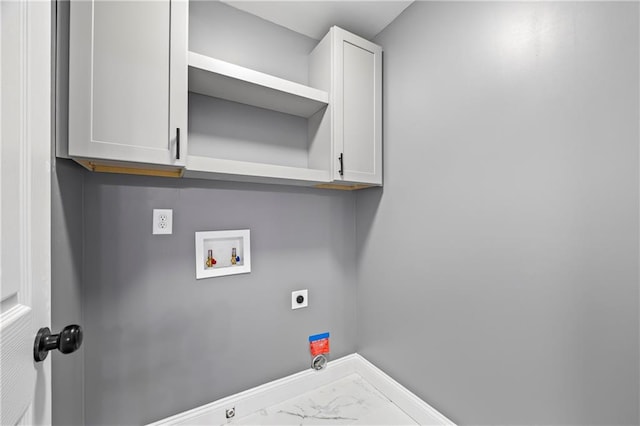 clothes washing area with hookup for a washing machine, cabinets, and hookup for an electric dryer