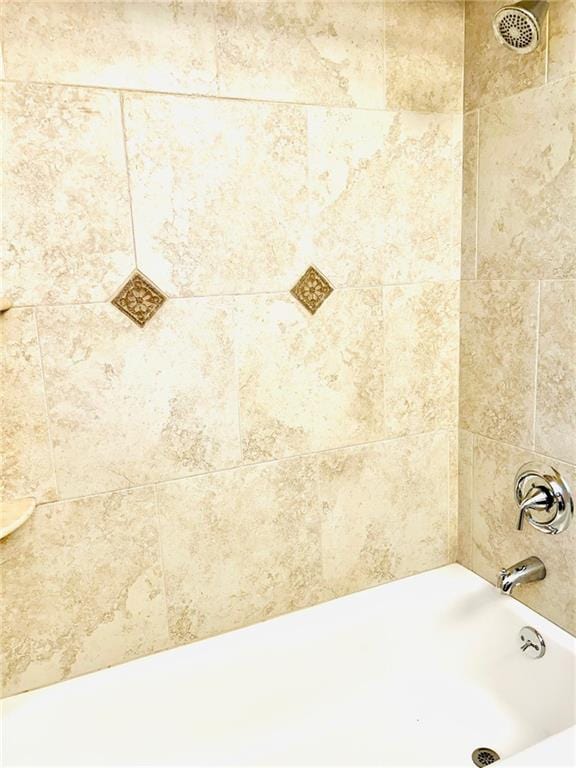 interior details featuring tub / shower combination