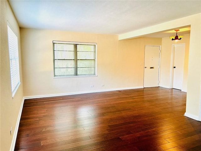 empty room featuring a healthy amount of sunlight and hardwood / wood-style floors