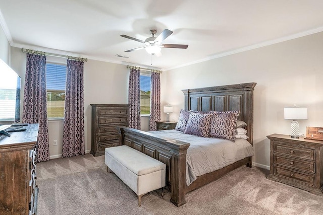 carpeted bedroom featuring a ceiling fan, baseboards, visible vents, and ornamental molding