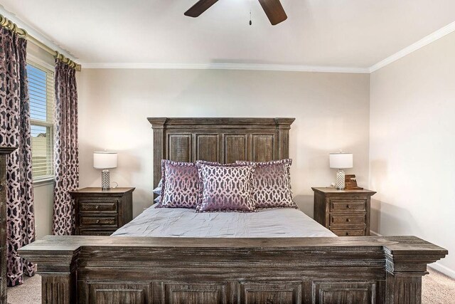 bedroom featuring carpet floors, a ceiling fan, crown molding, and baseboards