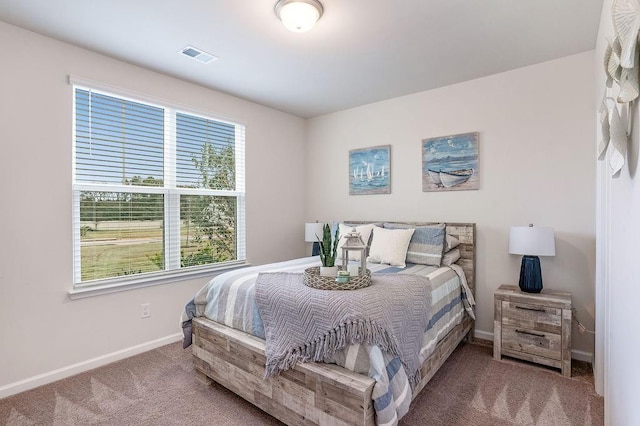 bedroom featuring baseboards, visible vents, and carpet
