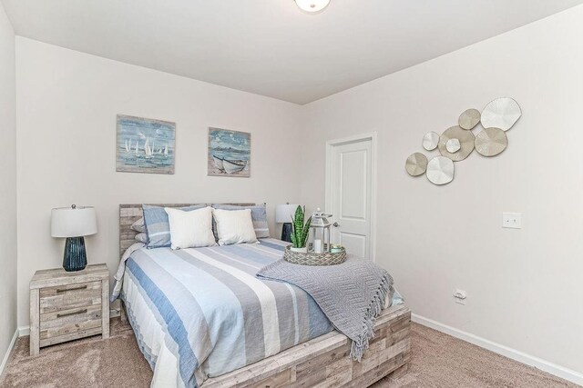 bedroom with carpet flooring and baseboards
