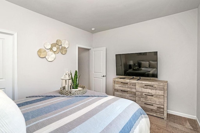 bedroom featuring baseboards and carpet