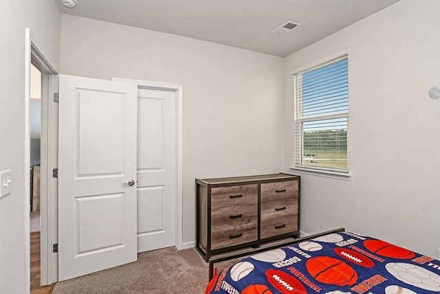 bedroom featuring carpet floors and visible vents