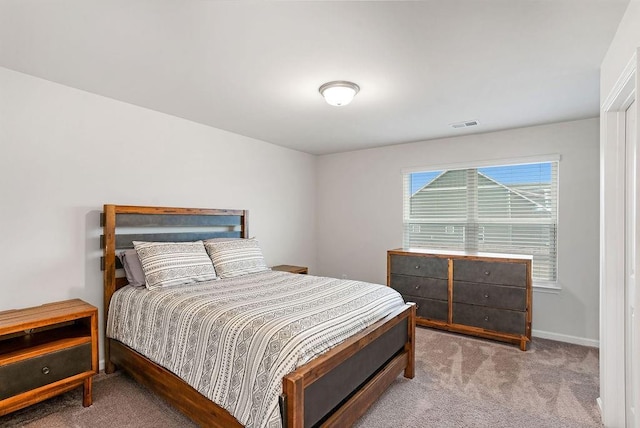 carpeted bedroom with baseboards and visible vents