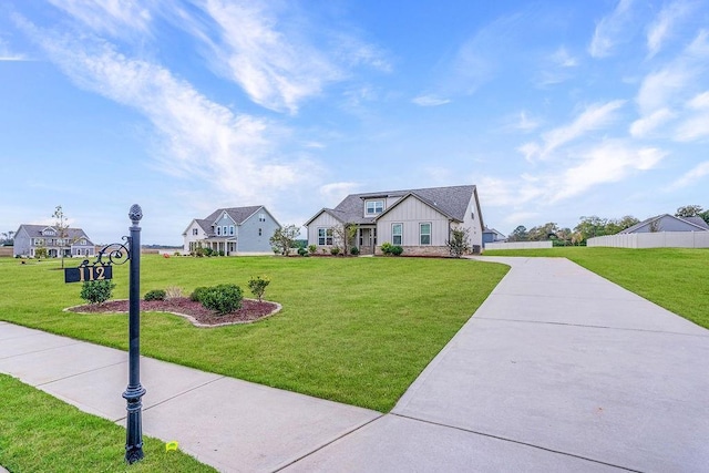 view of front of house with a front lawn, board and batten siding, and driveway