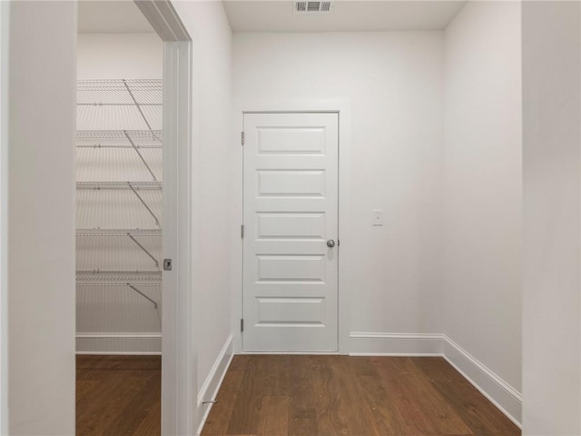 hallway featuring dark hardwood / wood-style flooring