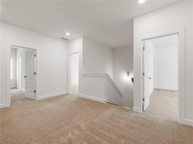 unfurnished room with light colored carpet