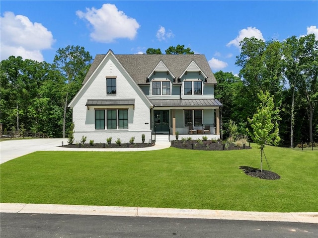 view of front of property with covered porch and a front yard