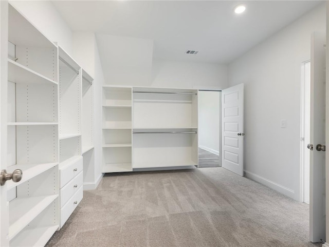 spacious closet featuring light carpet