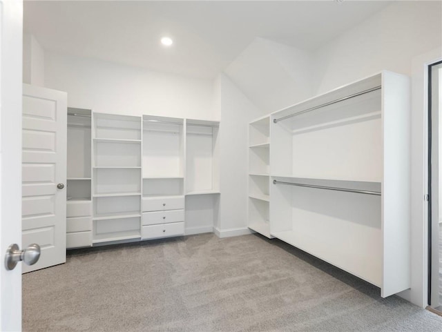 walk in closet featuring light carpet