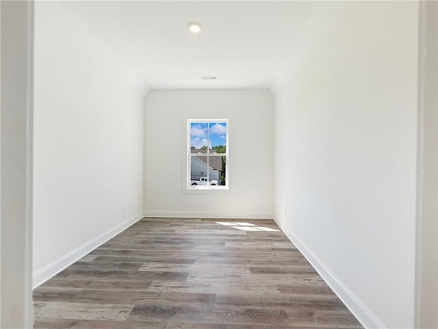 unfurnished room with hardwood / wood-style flooring