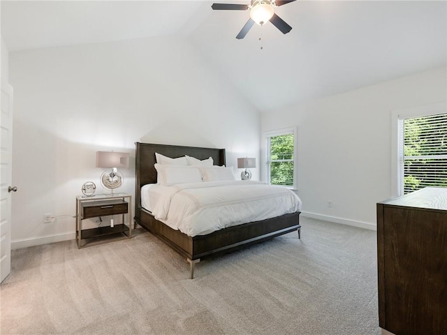 carpeted bedroom with ceiling fan, high vaulted ceiling, and multiple windows