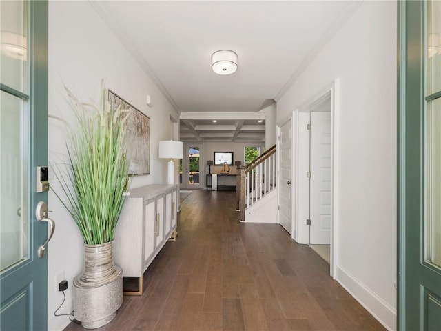 entryway with coffered ceiling, beamed ceiling, ornamental molding, and dark hardwood / wood-style floors