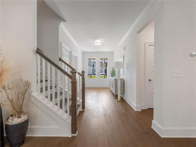 foyer featuring crown molding, french doors, and dark wood-type flooring