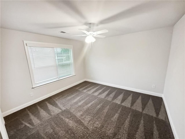 3650 Lindsy Brooke Ct, Douglasville, GA 30135 - spare room with dark colored carpet, ceiling fan, and baseboards