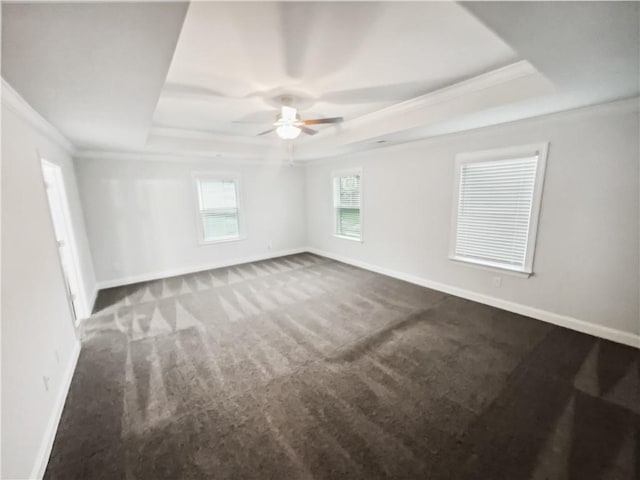 3650 Lindsy Brooke Ct, Douglasville, GA 30135 - unfurnished room with a tray ceiling, dark carpet, ornamental molding, a ceiling fan, and baseboards