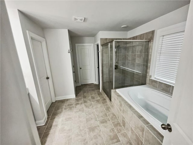 3650 Lindsy Brooke Ct, Douglasville, GA 30135 - full bathroom featuring a bath, a stall shower, tile patterned flooring, and baseboards