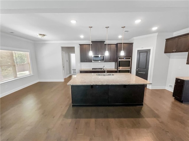 kitchen featuring baseboards, dark wood-style floors, stainless steel appliances, dark brown cabinets, and a sink